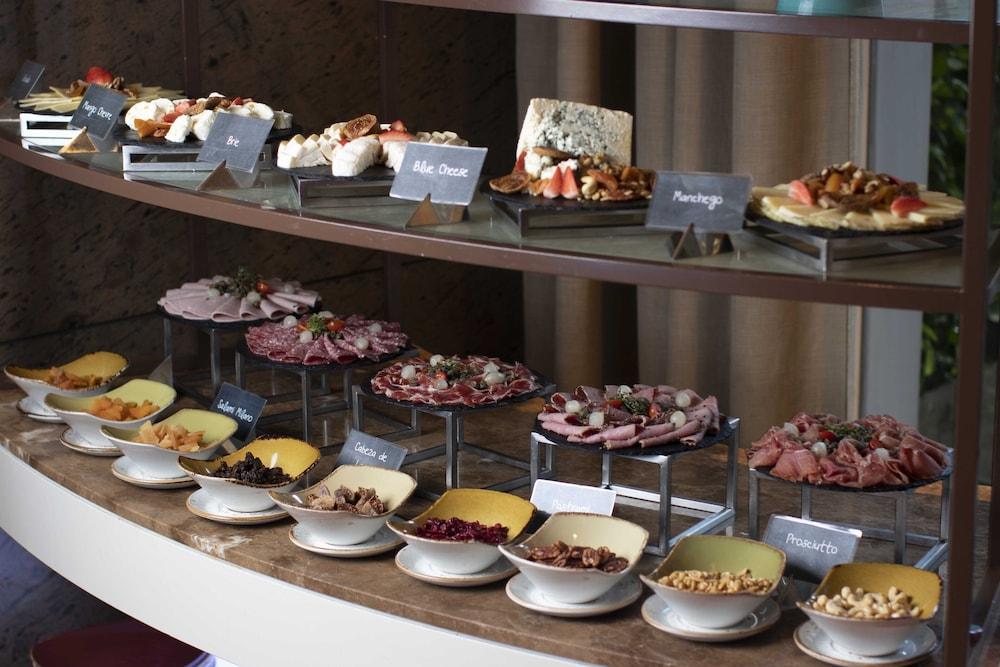 Discovery Primea Makati City Exterior photo A selection of cold cuts and cheese at a buffet